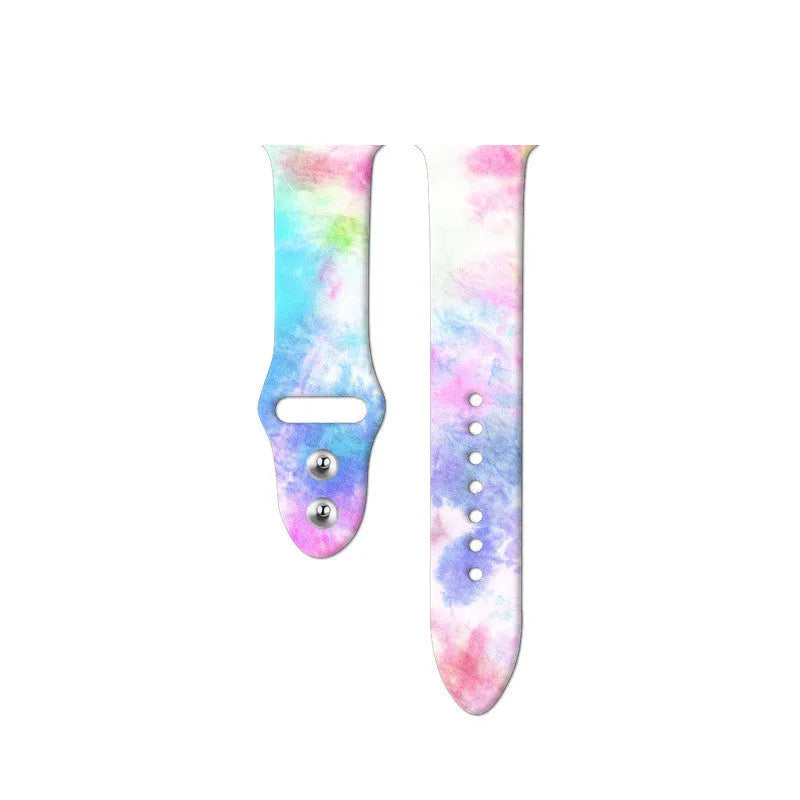 Apple Watch silicone band with colourful tie-dye pattern, shown attached to a watch and laid flat