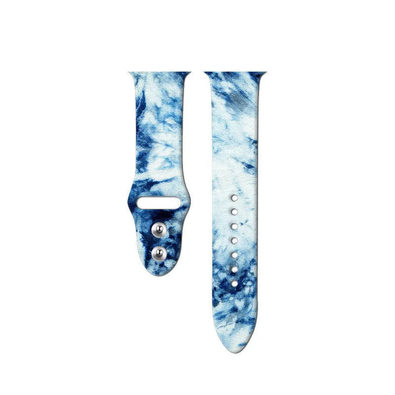 Apple Watch silicone band with colourful tie-dye pattern, shown attached to a watch and laid flat