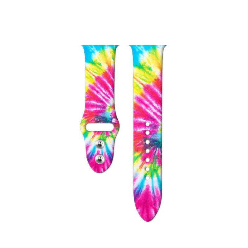 Apple Watch silicone band with colourful tie-dye pattern, shown attached to a watch and laid flat