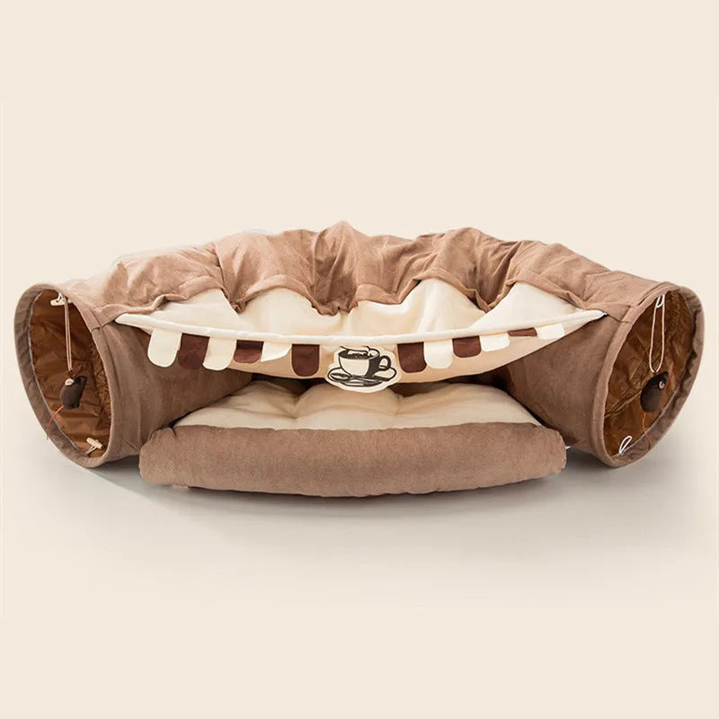 Collapsible cloth cat tunnel in pink colour, shown in both open and folded positions.