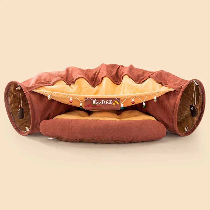 Collapsible cloth cat tunnel in pink colour, shown in both open and folded positions.
