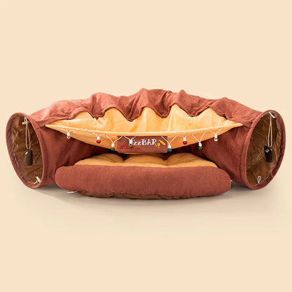 Collapsible cloth cat tunnel in pink colour, shown in both open and folded positions.
