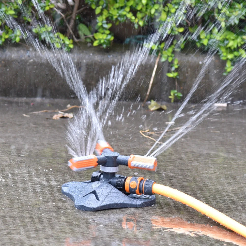 Adjustable 360-degree 3-arm rotating sprinkler in green and orange for efficient lawn irrigation