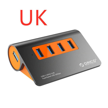 Dark grey and orange aluminium laptop hub with four USB ports, a blue LED light, and a detached cable.