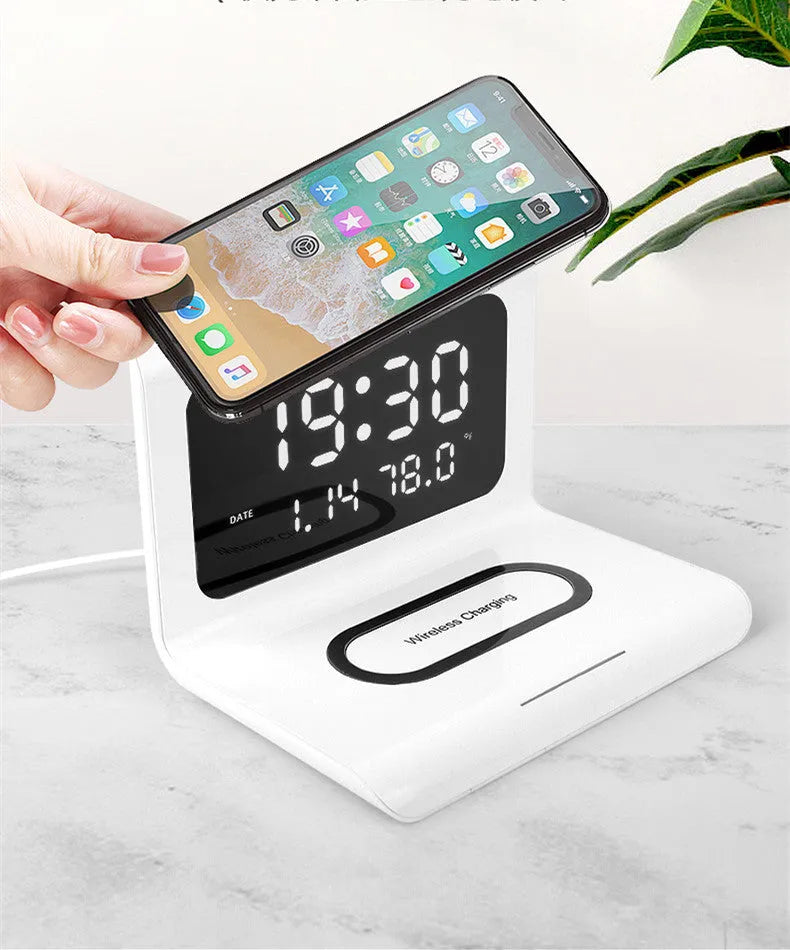 White wireless charger alarm clock showing time, date, temperature display with phone charging