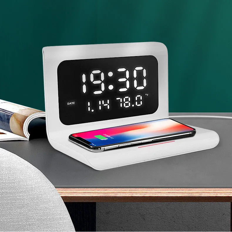 White wireless charger alarm clock showing time, date, temperature display with phone charging