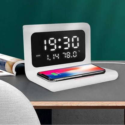 White wireless charger alarm clock showing time, date, temperature display with phone charging