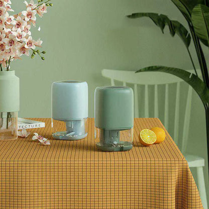 Mini portable dehumidifier in white, blue, or dark green with 0.7L water tank