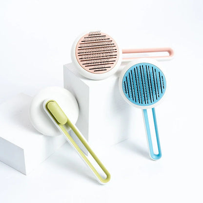 Automatic pet hair remover brush in pink, blue, and green with stainless steel pins