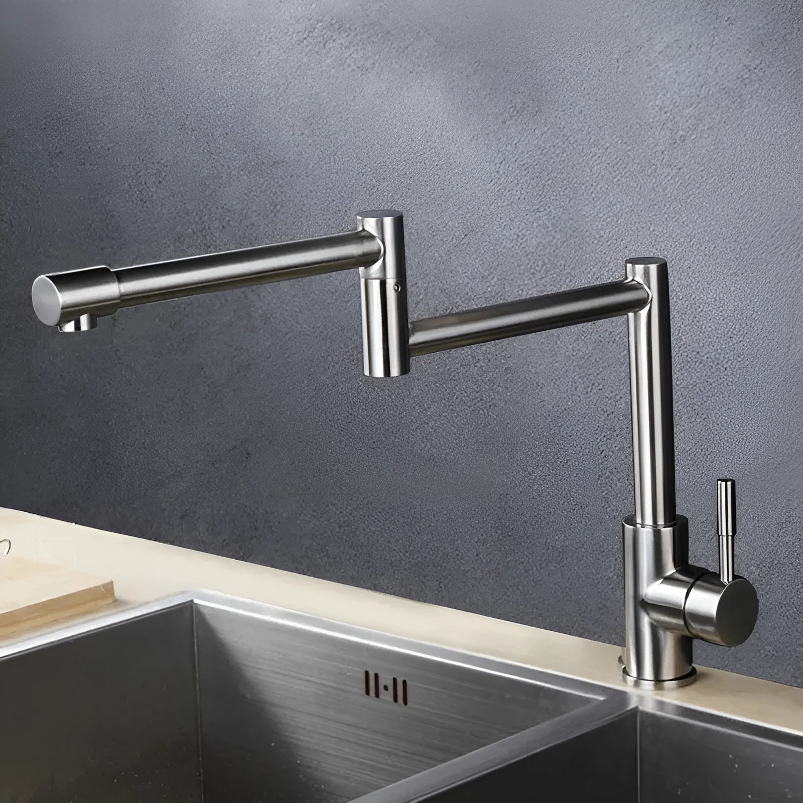 Brushed silver stainless steel kitchen mixer tap with a spout rotated to the side