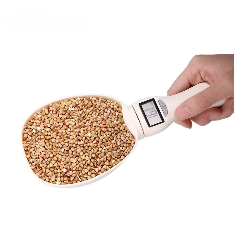 Compact digital kitchen scale with sleek beige design, showing four measurement units and detachable spoon for convenient use in home baking and cooking.