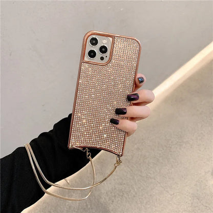 Glitter rhinestone TPU iPhone case with necklace lanyard strap in black, shown on an iPhone 12.