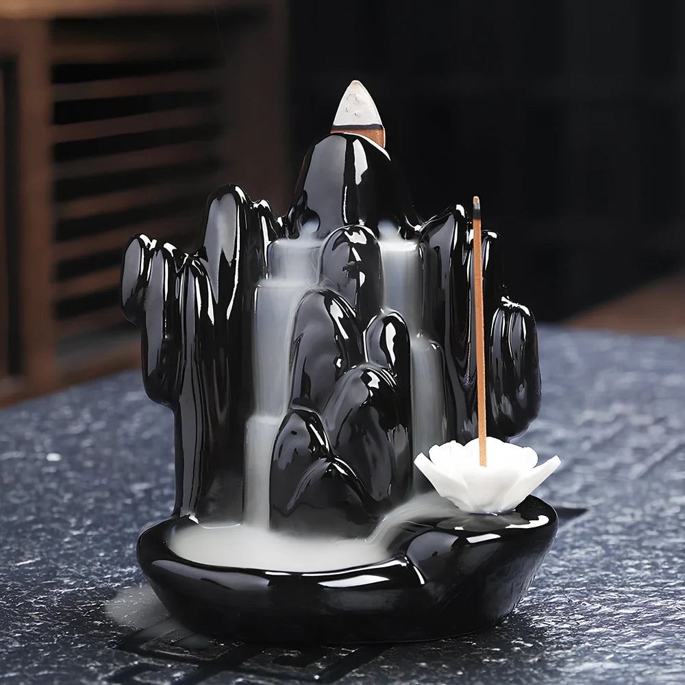 Black ceramic backflow incense burner creating waterfall smoke with sandalwood aroma