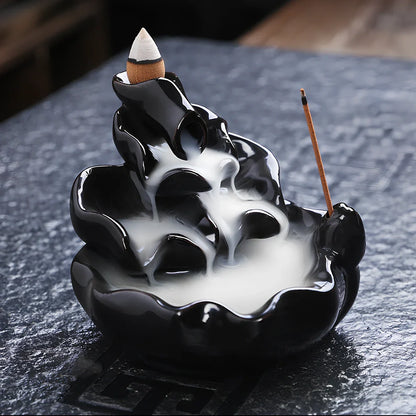 Black ceramic backflow incense burner creating waterfall smoke with sandalwood aroma