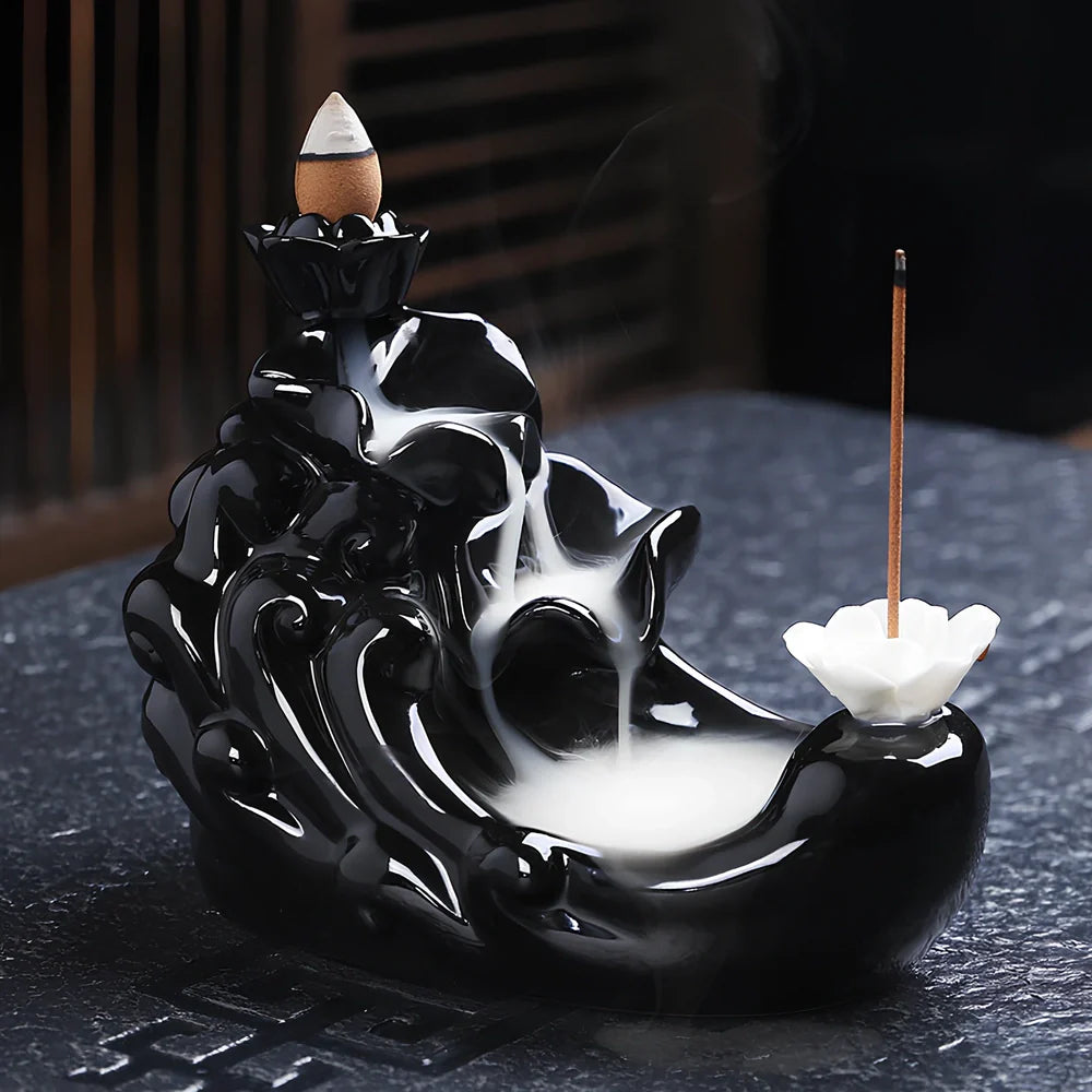 Black ceramic backflow incense burner creating waterfall smoke with sandalwood aroma