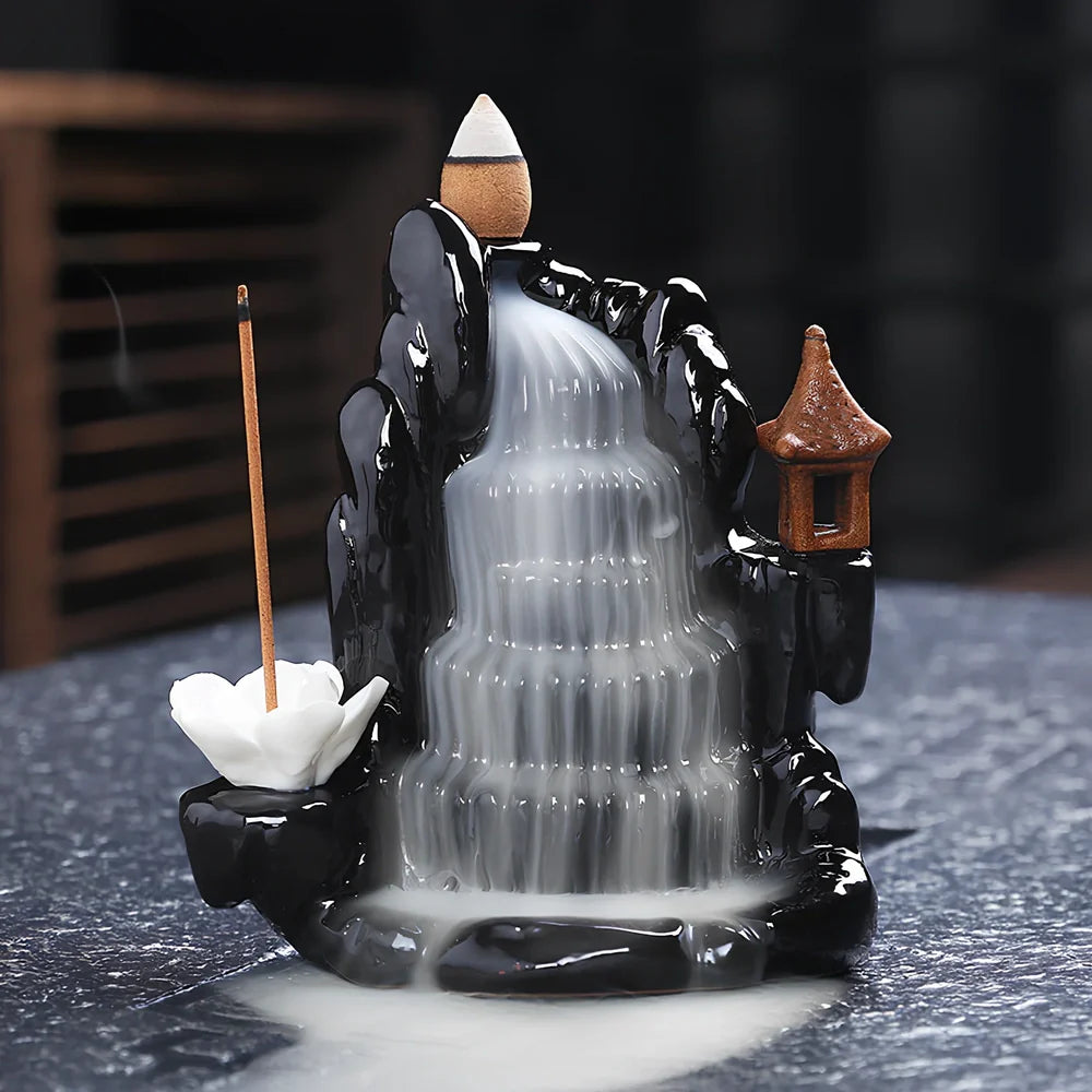 Black ceramic backflow incense burner creating waterfall smoke with sandalwood aroma