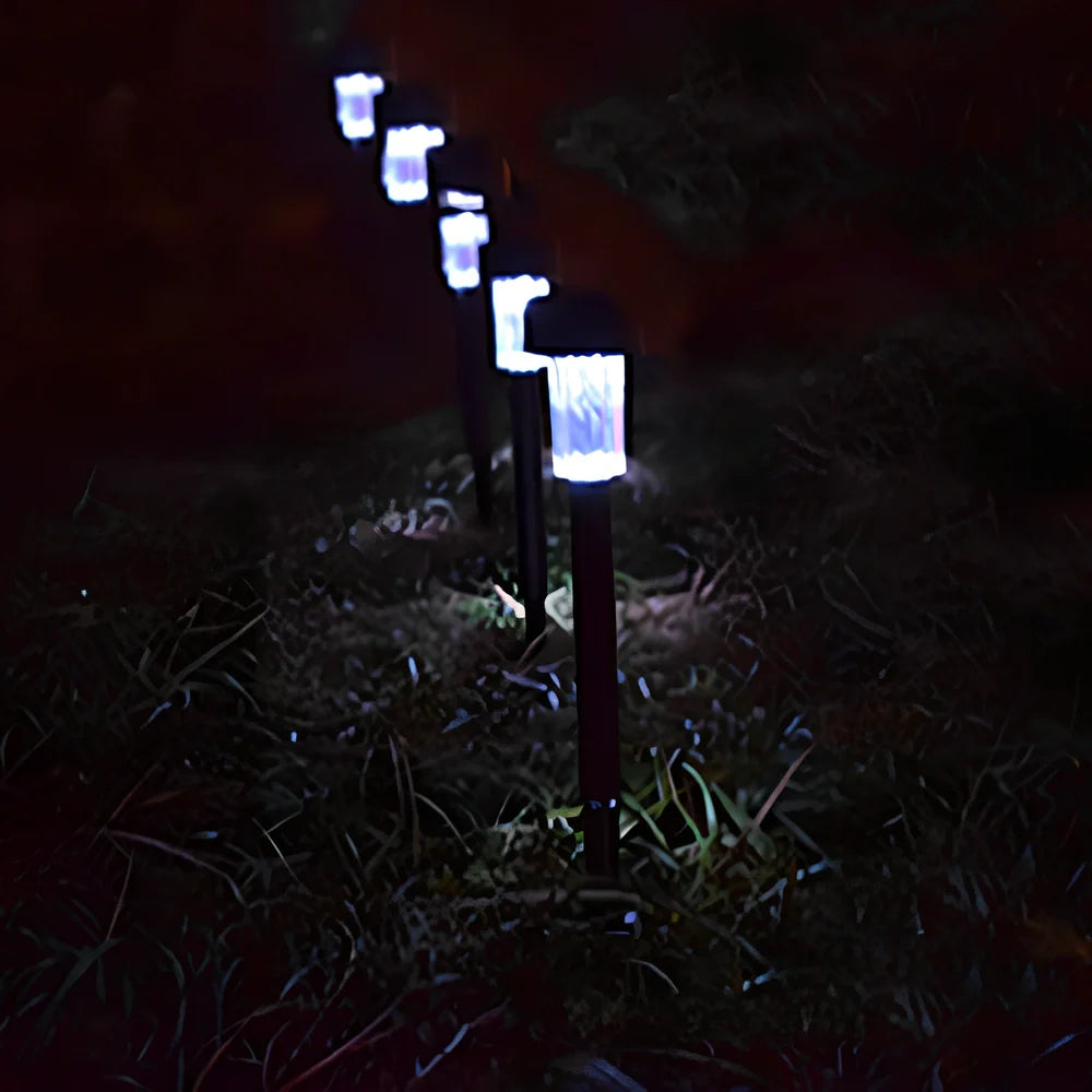 Solar lawn light with LED illumination in garden setting, measuring 55mm by 55mm by 350mm