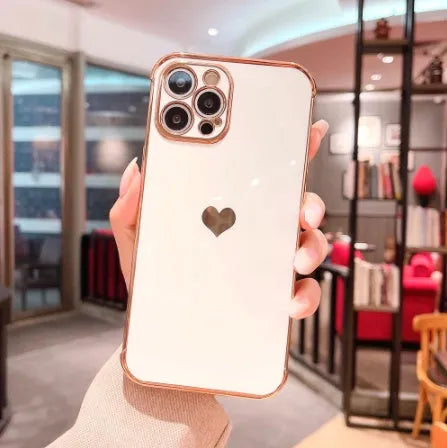 White iPhone case with a silver electroplated love design on the back, showing its flexible TPU anti-fall construction.