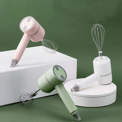 Green rechargeable electric hand mixer with whisk and beater attachments on a kitchen counter