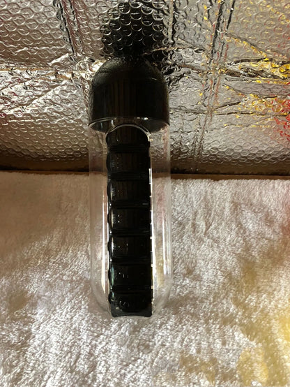 Water bottle with seven pill compartments attached, showing 600ml capacity and BPA-free construction