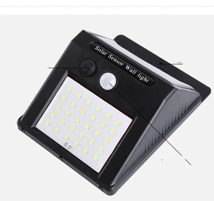 Solar-powered outdoor garden lamp with motion sensor mounted on wooden post