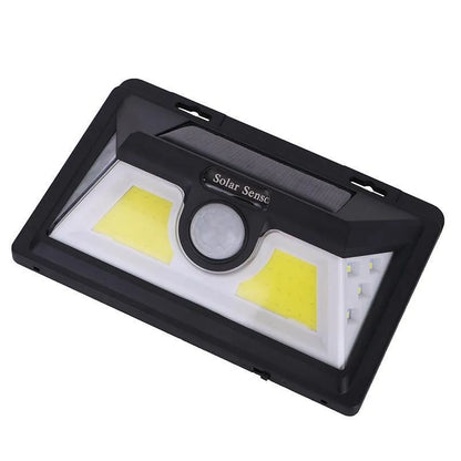 Solar-powered outdoor garden lamp with motion sensor mounted on wooden post