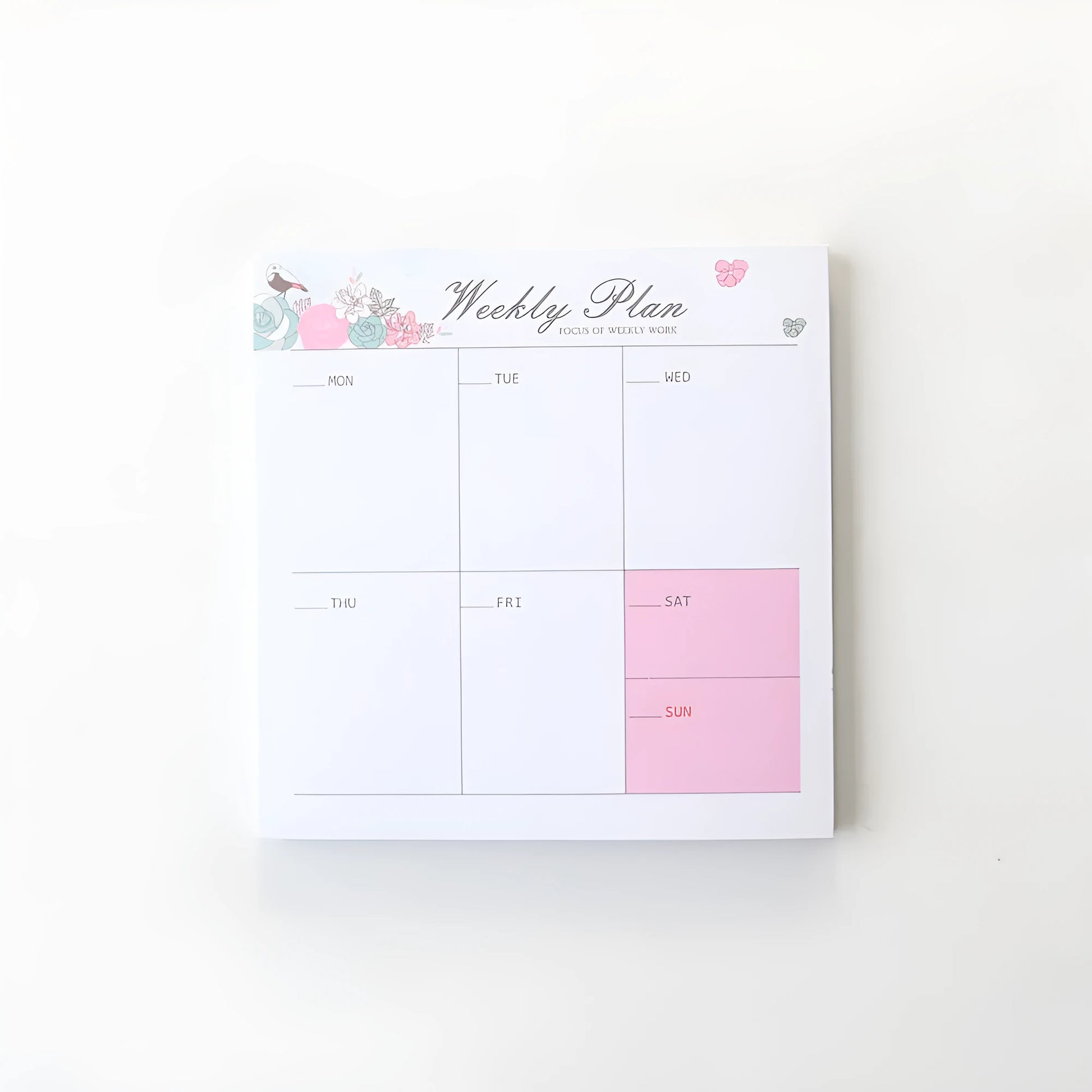 Paper brick desk organiser pad showing weekly and monthly planning sections with pink and green mixed colours