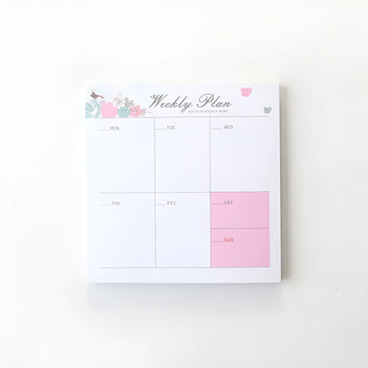 Paper brick desk organiser pad showing weekly and monthly planning sections with pink and green mixed colours