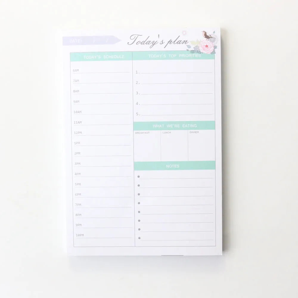 Paper brick desk organiser pad showing weekly and monthly planning sections with pink and green mixed colours