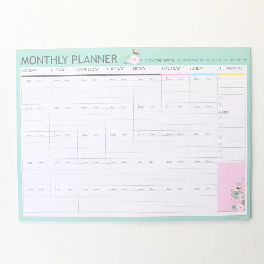Paper brick desk organiser pad showing weekly and monthly planning sections with pink and green mixed colours