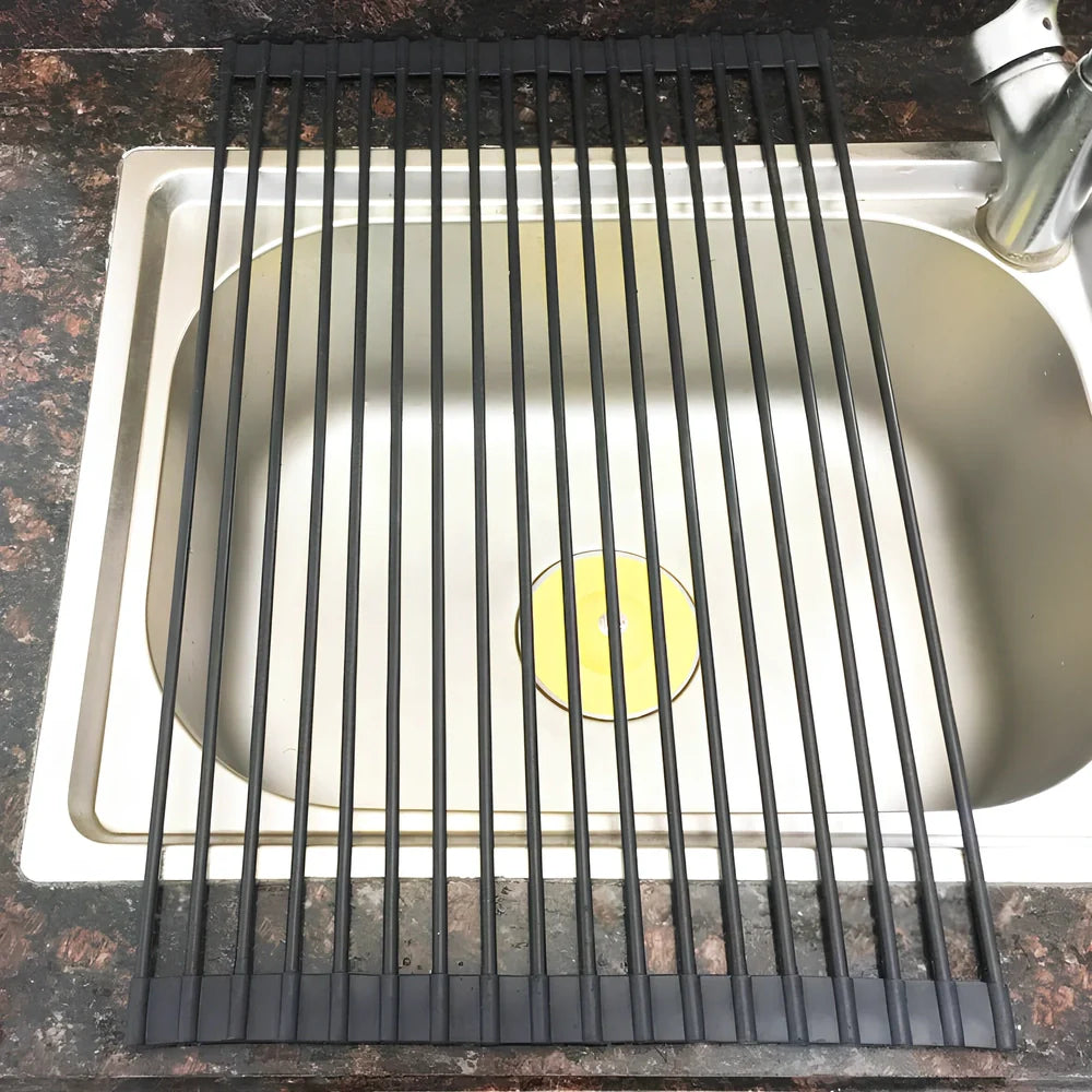Stainless steel sink drain rack with rolling curtain design folded to show compact 5cm storage thickness