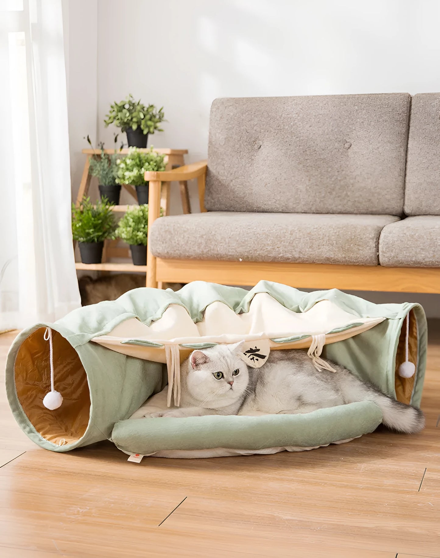 Collapsible cloth cat tunnel in pink colour, shown in both open and folded positions.