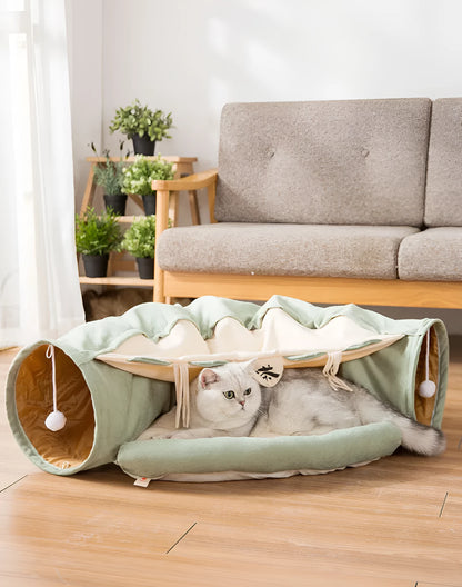 Collapsible cloth cat tunnel in pink colour, shown in both open and folded positions.