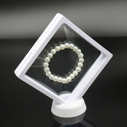 3D floating jewelry coin display stand in white and black, showcasing collectibles in mid-air
