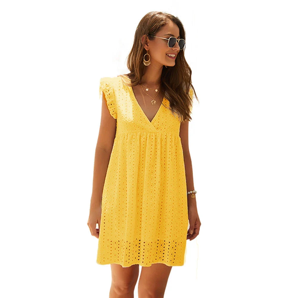Chic cotton mini dress with floral embroidery and v-neck design for a romantic, summer-ready look