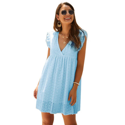 Chic cotton mini dress with floral embroidery and v-neck design for a romantic, summer-ready look