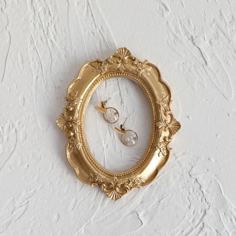 Golden retro photo frame for jewelry and art display in Nordic style