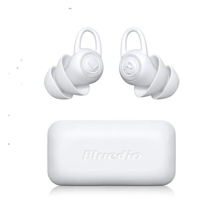 A single pair of smooth white silicone ear plugs for noise reduction.