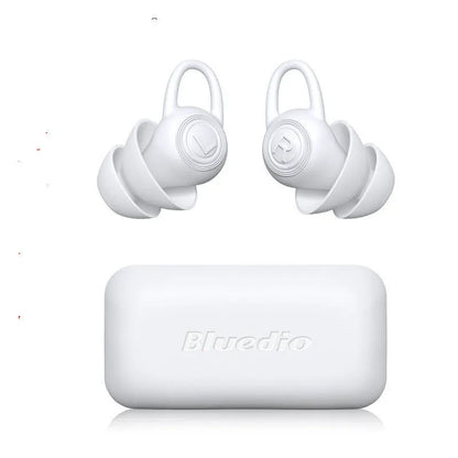 A single pair of smooth white silicone ear plugs for noise reduction.
