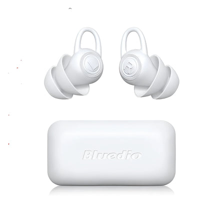 A single pair of smooth white silicone ear plugs for noise reduction.