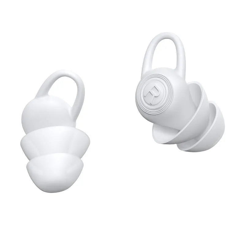 A single pair of smooth white silicone ear plugs for noise reduction.