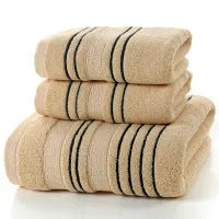 Household pure cotton towel set showing one large bath towel and two smaller hand towels in a neutral colour like grey or khaki.