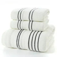 Household pure cotton towel set showing one large bath towel and two smaller hand towels in a neutral colour like grey or khaki.
