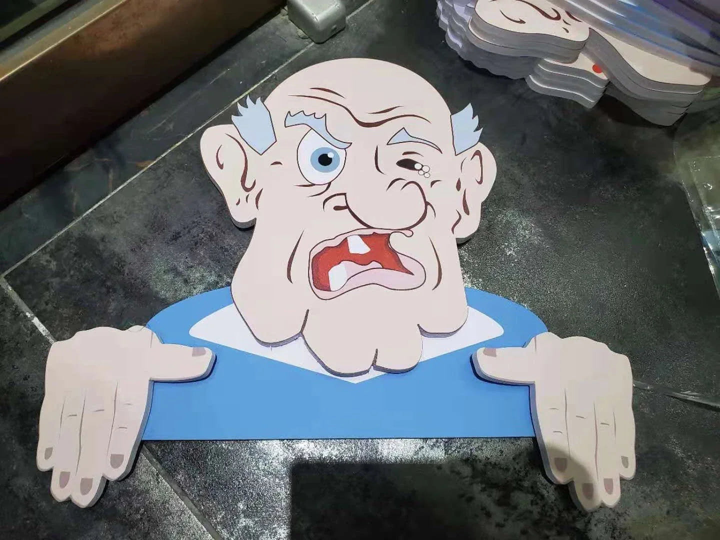 Charming garden fence decorations featuring quirky depictions of curious older adults