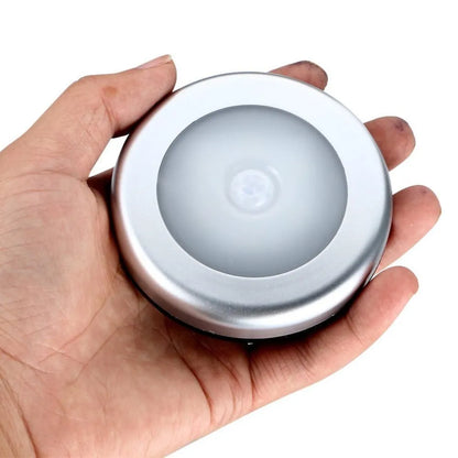 Silver square wireless motion sensor night light on a wall, 80mm wide, showing LED illumination.