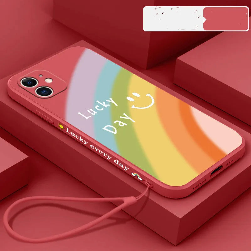 Rainbow smiley silicone phone case for iPhone in blue, showing all-inclusive design and back cover detail.