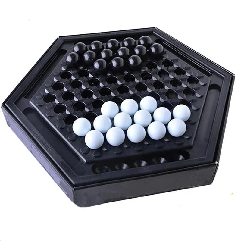 Abalone family board game with marble pieces on a wooden game board