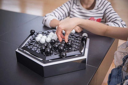 Abalone family board game with marble pieces on a wooden game board