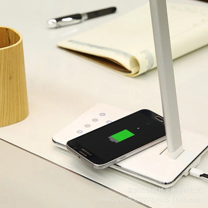 Black and white wireless charging LED desk lamp with USB cable and touch control.
