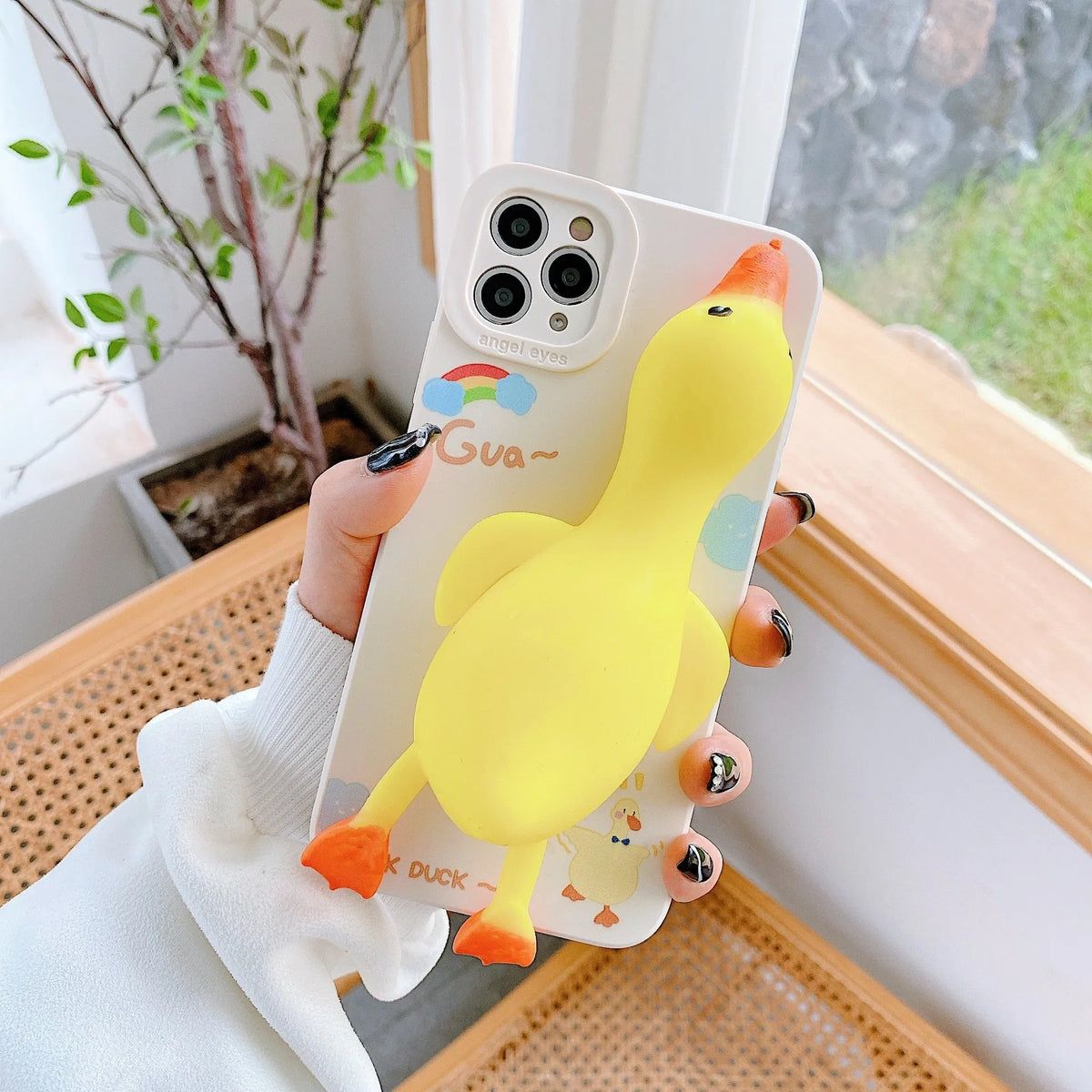 iPhone silicone phone case with straight sides and cartoon print design in yellow, white, or pink